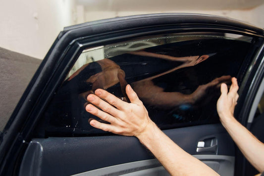 A man is in the process of opening a car door, ready to enter the vehicle