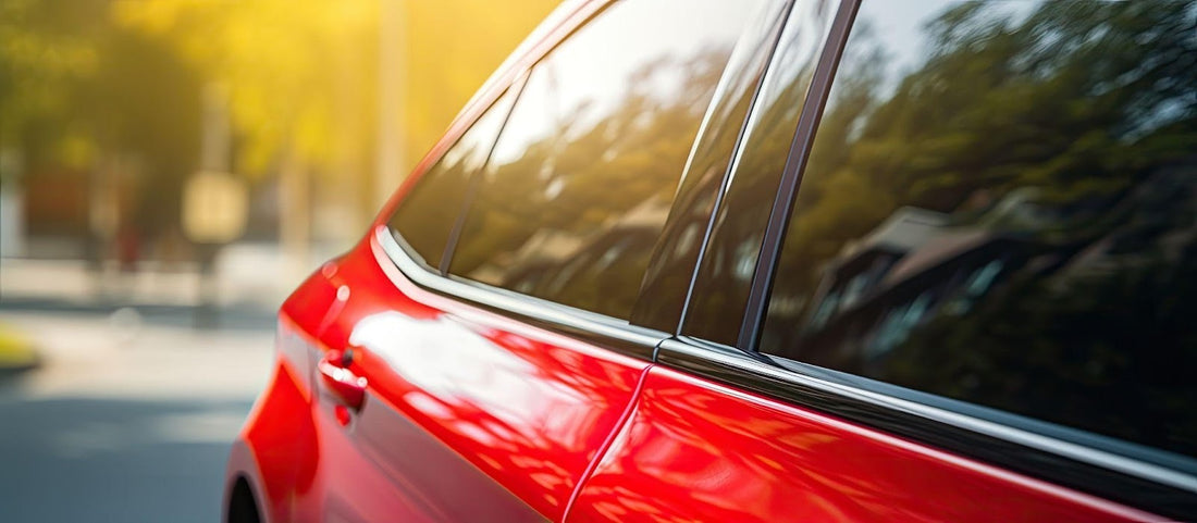 A red car parked on the street, showcasing its vibrant color against the urban backdrop