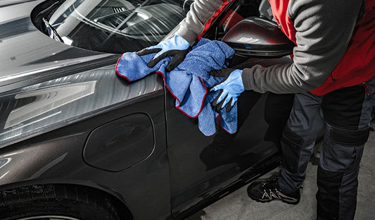A Man Cleaning the Hood of a Car With Paint Protection, Protective Coating, Pre cut Paint Protection Film
