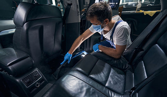Man in blue glove cleaning car interior with Car Tint, Automatic Tinted Windows, Anti Fog for Windshields