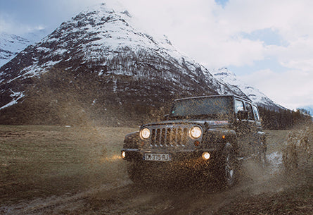 A four wheel vehicle running in muddy ground