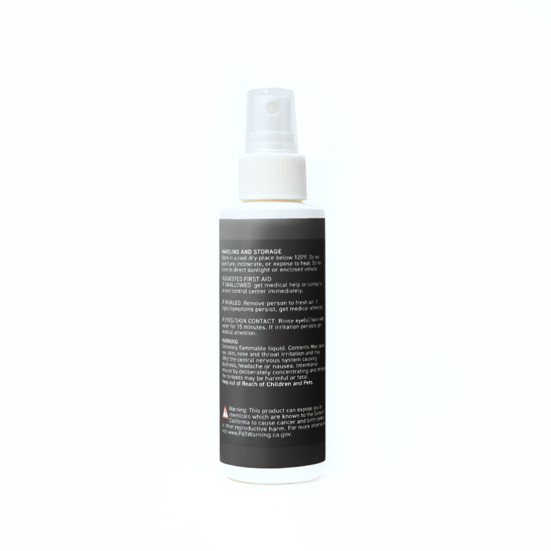 A bottle of body spray positioned on a clean white background, showcasing its sleek design and vibrant label.